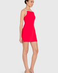 model wearing a red dress with ivory straps standing on a white background