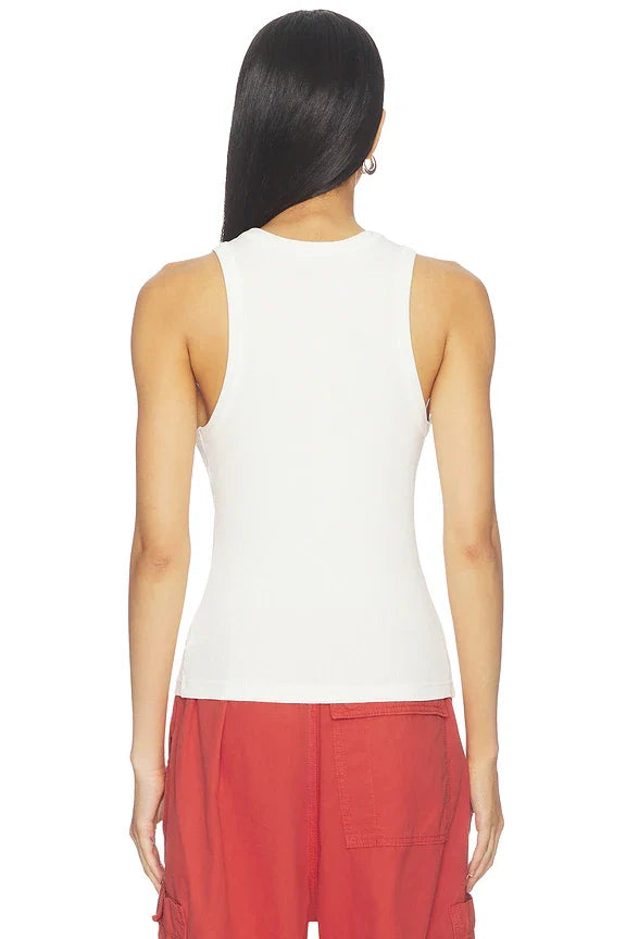 A woman shown from the back wearing a fitted sleeveless white top and red cargo-style pants against a plain white studio background.