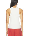 A woman shown from the back wearing a fitted sleeveless white top and red cargo-style pants against a plain white studio background.