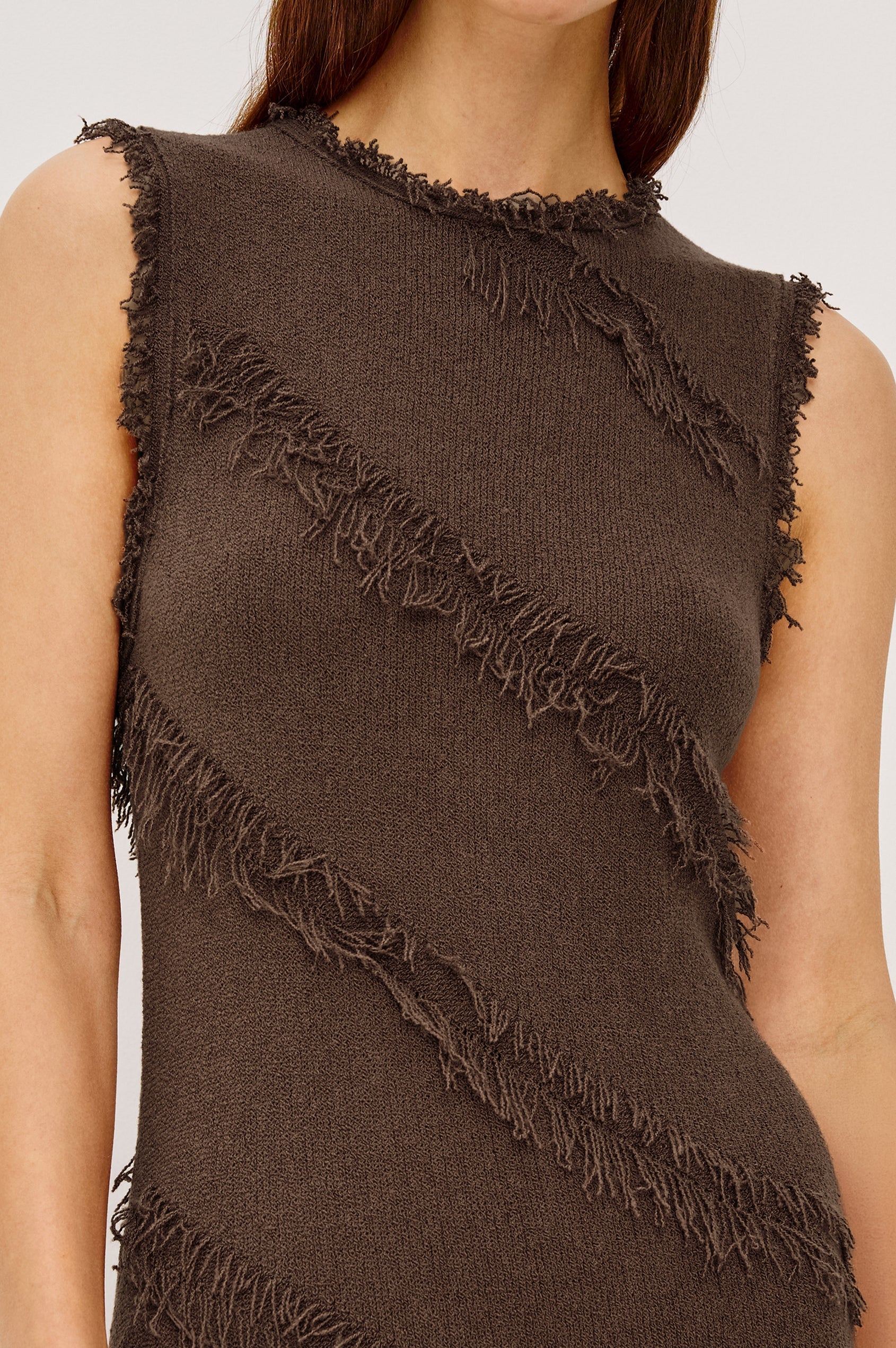 Brown sleeveless top with fringe details on a white background