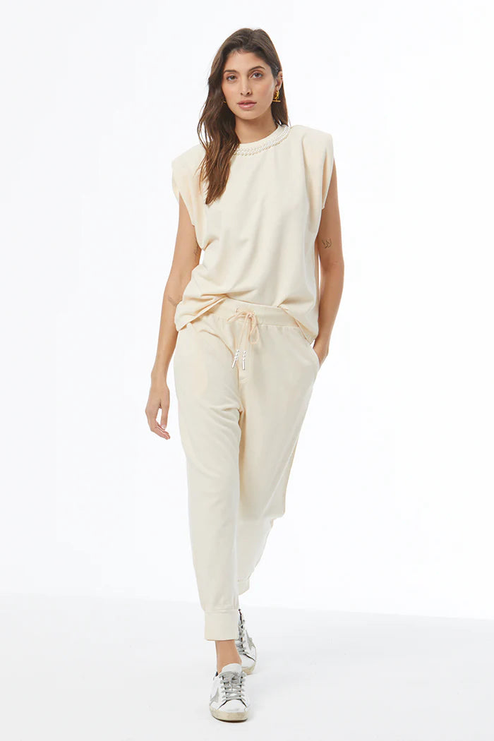 Woman wearing a beige outfit on a white background