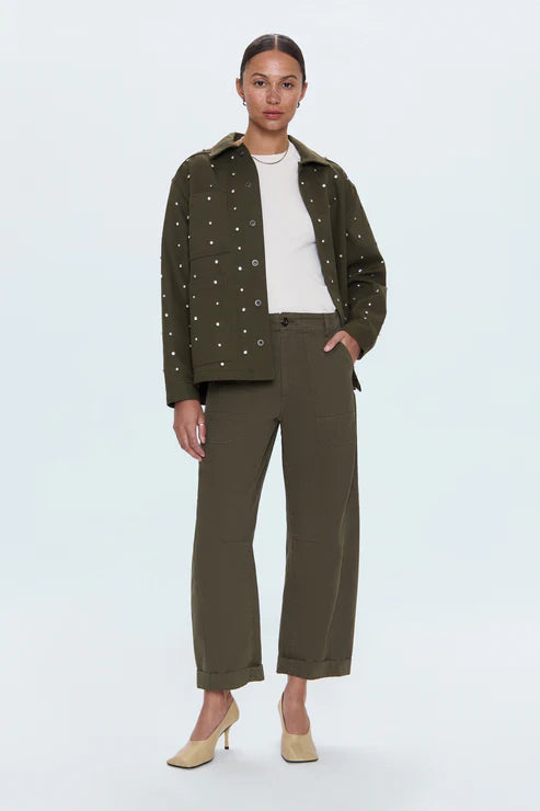 Woman wearing a green jacket and pants on a white background
