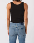 Person wearing a black tank top and blue jeans on a white background