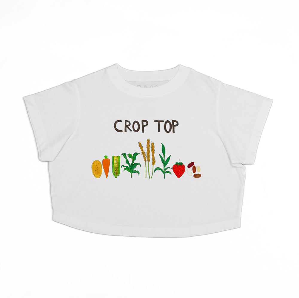 A white cropped short-sleeve baby t-shirt featuring a graphic print of various vegetables and the text 'CROP TOP' in brown lettering.
