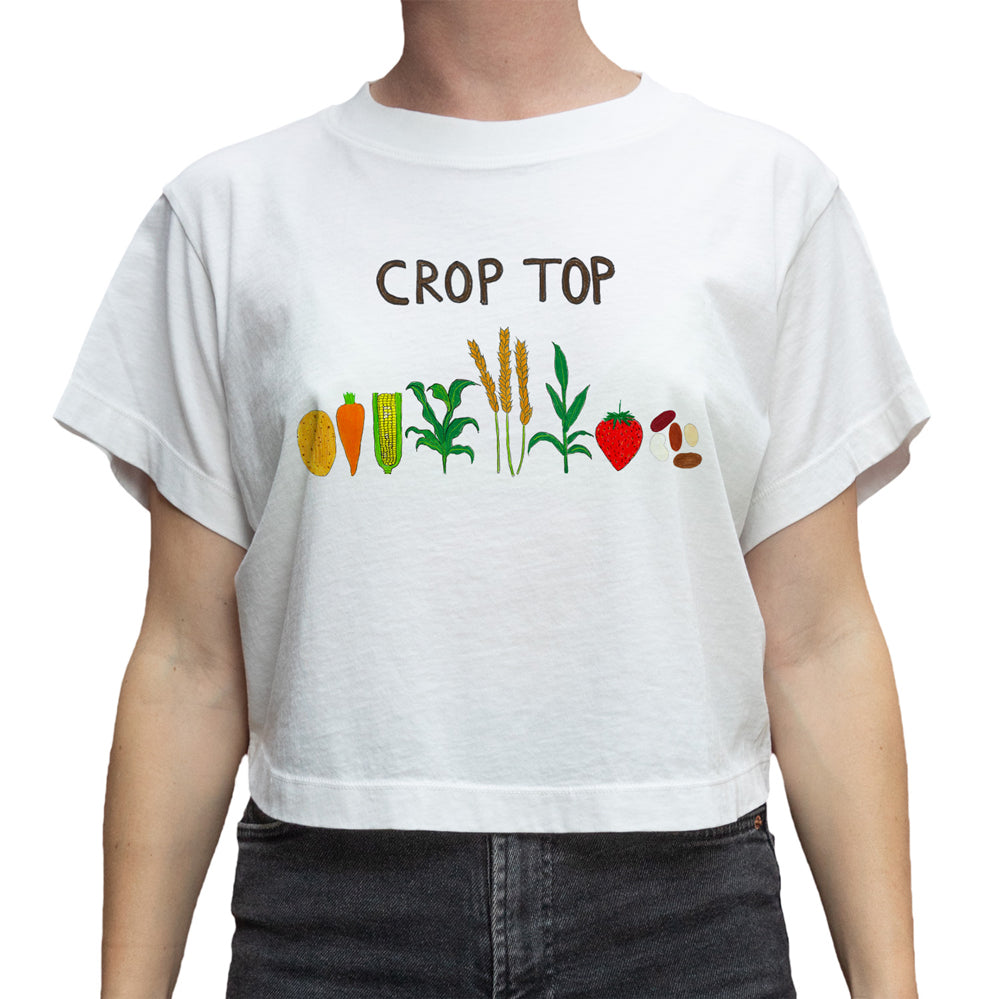A white short-sleeve crop top t-shirt featuring a colorful graphic of various vegetables and grains with the text 'CROP TOP' printed above them, shown on a model.