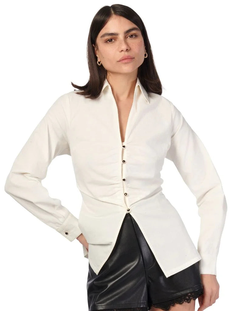 Woman wearing a white blouse with a unique design on a white background front view