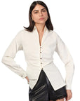 Woman wearing a white blouse with a unique design on a white background front view
