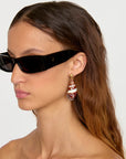Caracol Earrings left side view on model