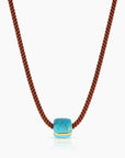 Necklace with a turquoise pendant on a white background