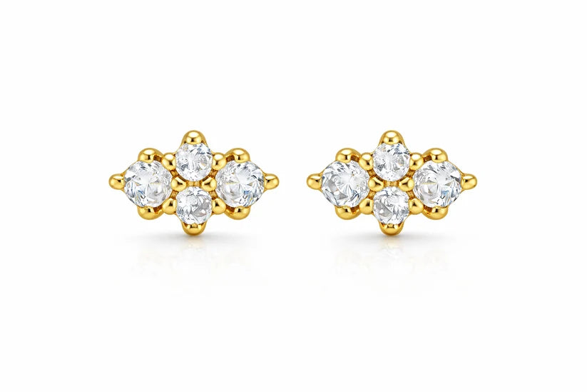 A pair of yellow gold stud earrings, each featuring a cluster of clear round-cut gemstones in a floral or snowflake-like arrangement, set against a plain white background.
