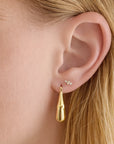 Dory Diamond Earrings on model's ear paired with a drop earring