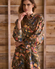 Woman wearing a floral dress against a wooden background