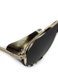 Sunglasses with gold frame and black lenses on a white background