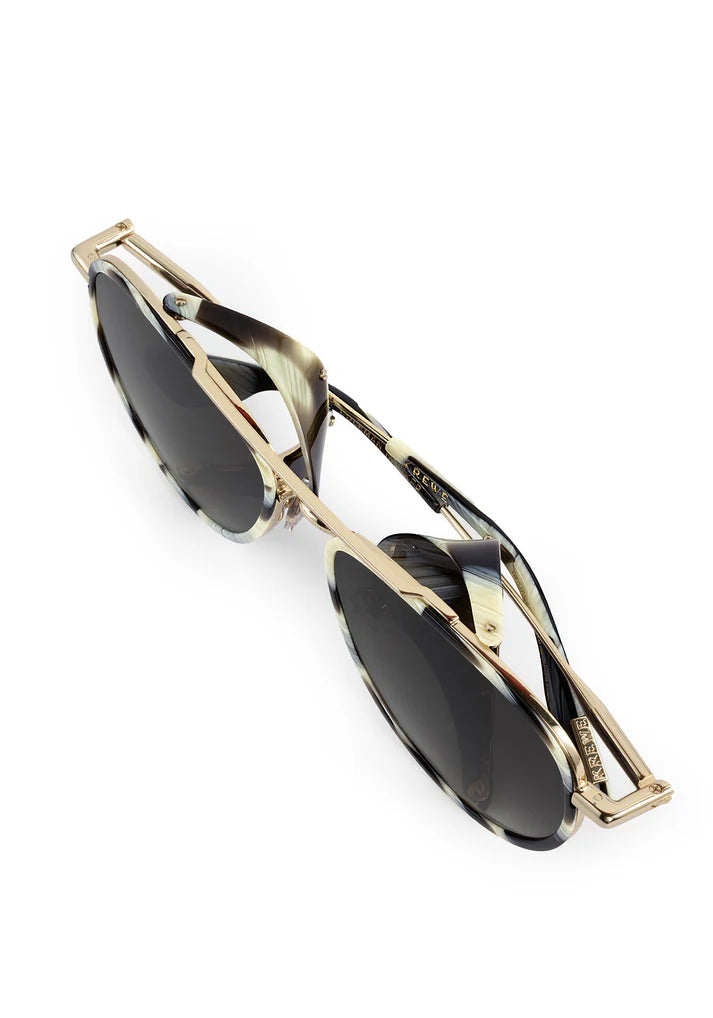 Gold-framed sunglasses with black lenses on a white background