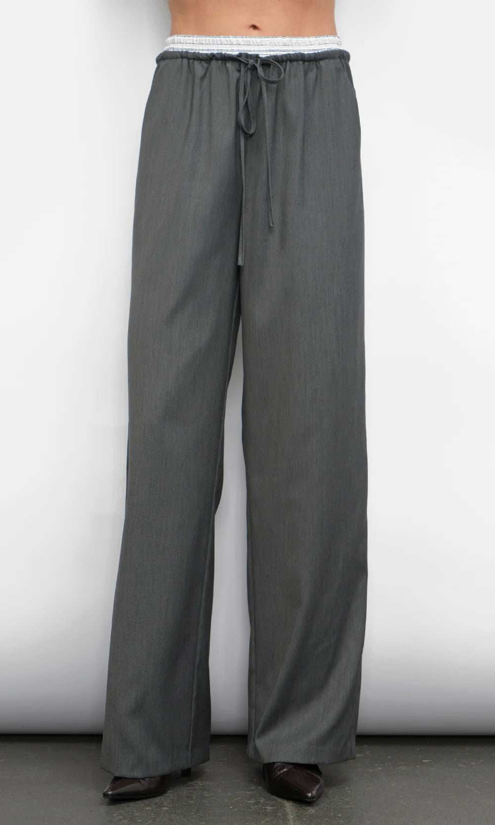 Gray wide-leg pants worn by a person on a white background