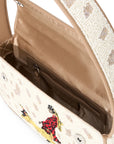 Close-up of a handbag interior and upper flap, showing a beige satin-lined compartment, brown zipper, and a cream patterned exterior with a small embroidered figure in red and yellow.