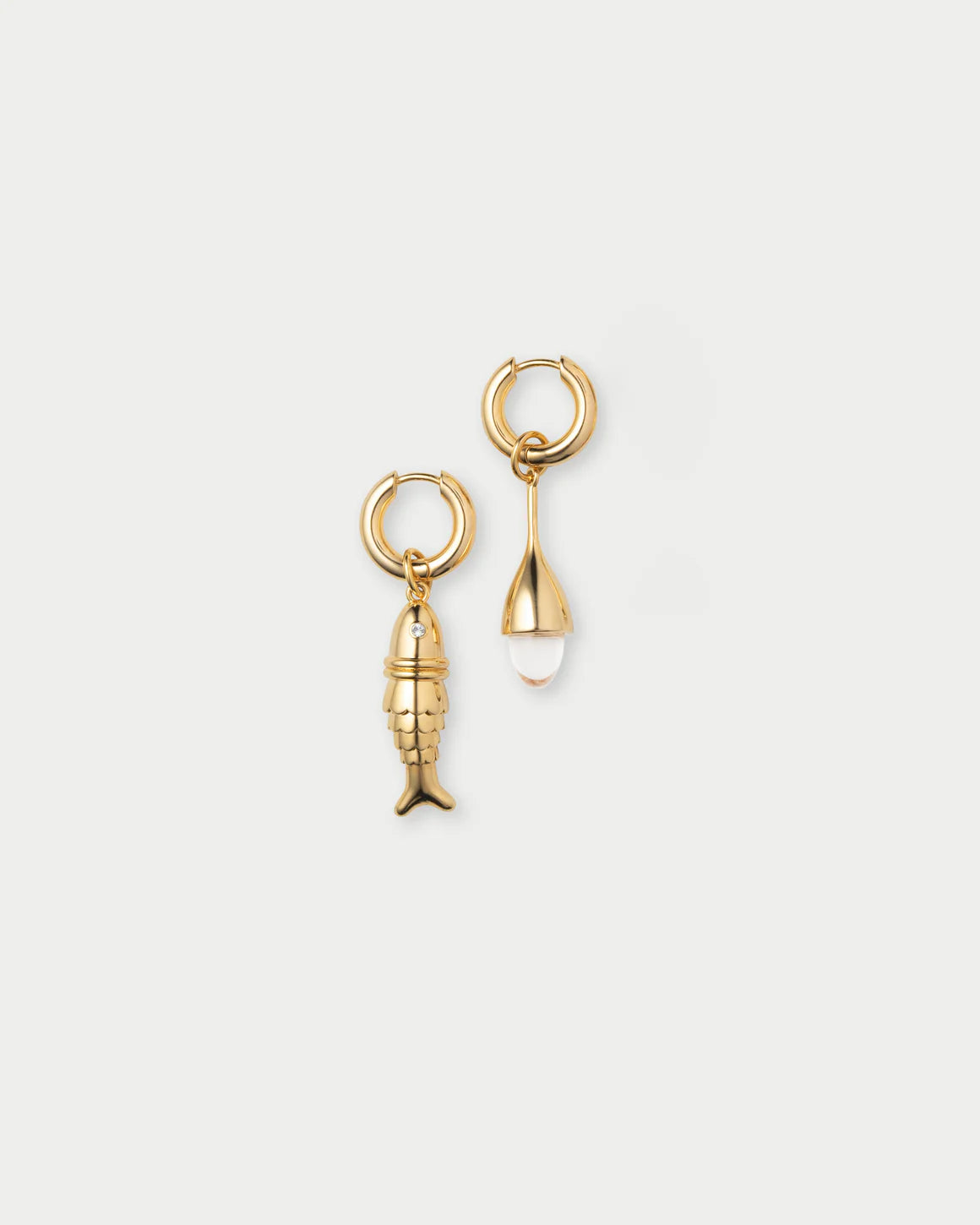 Gold fish-shaped earring on a white background