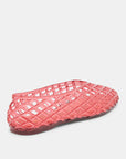 Coral woven sandal on a light gray background