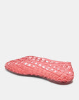 Pink woven shoe on a light gray background