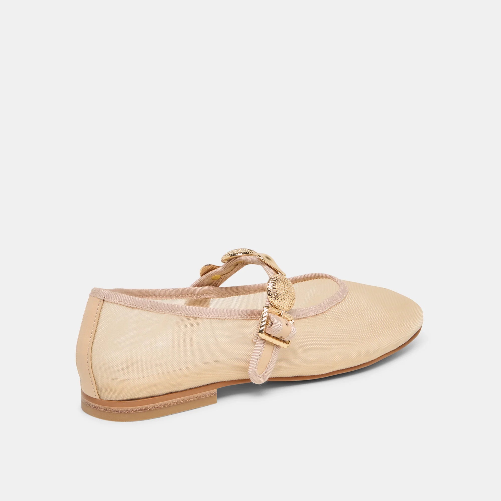 Beige flat shoe with a decorative strap on a white background