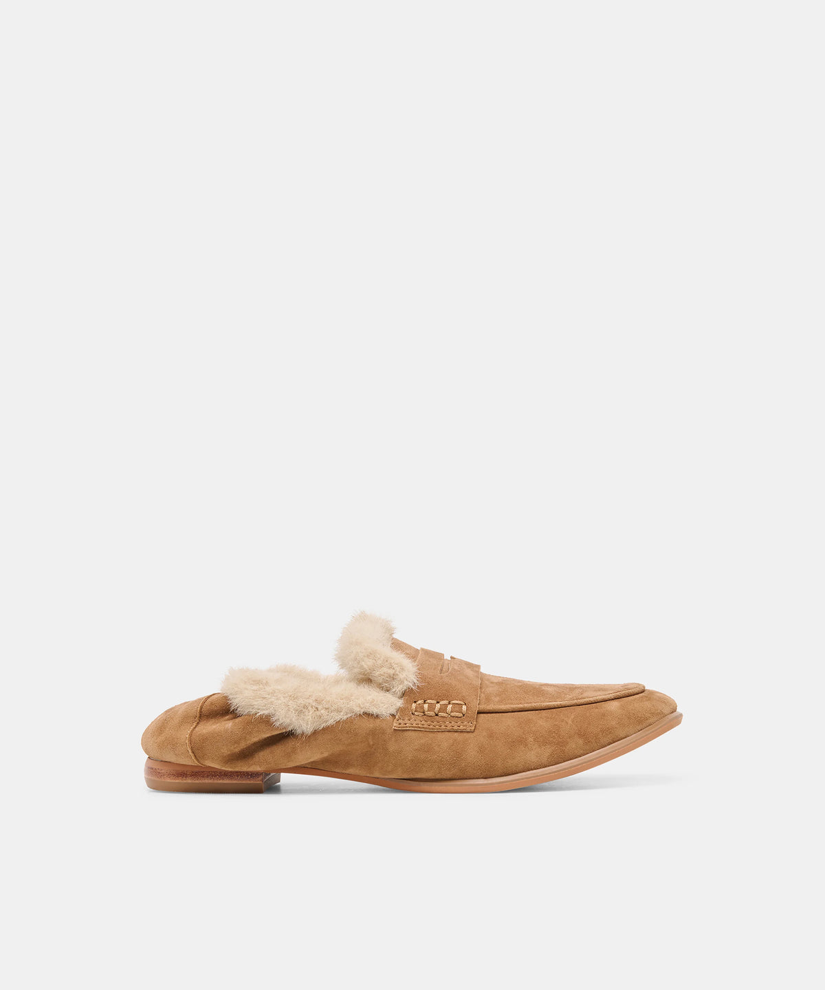 A tan suede slip-on loafer with a fluffy cream shearling lining, shown in profile against a light gray background.