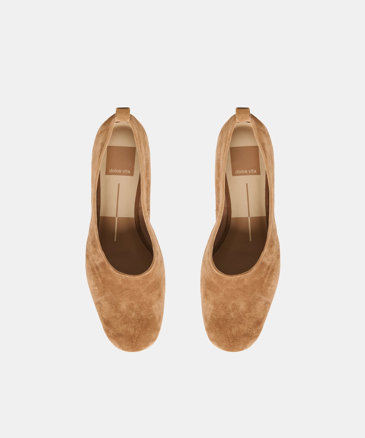 A pair of tan suede slip-on shoes with low block heels, shown from a top-down view on a light gray background.