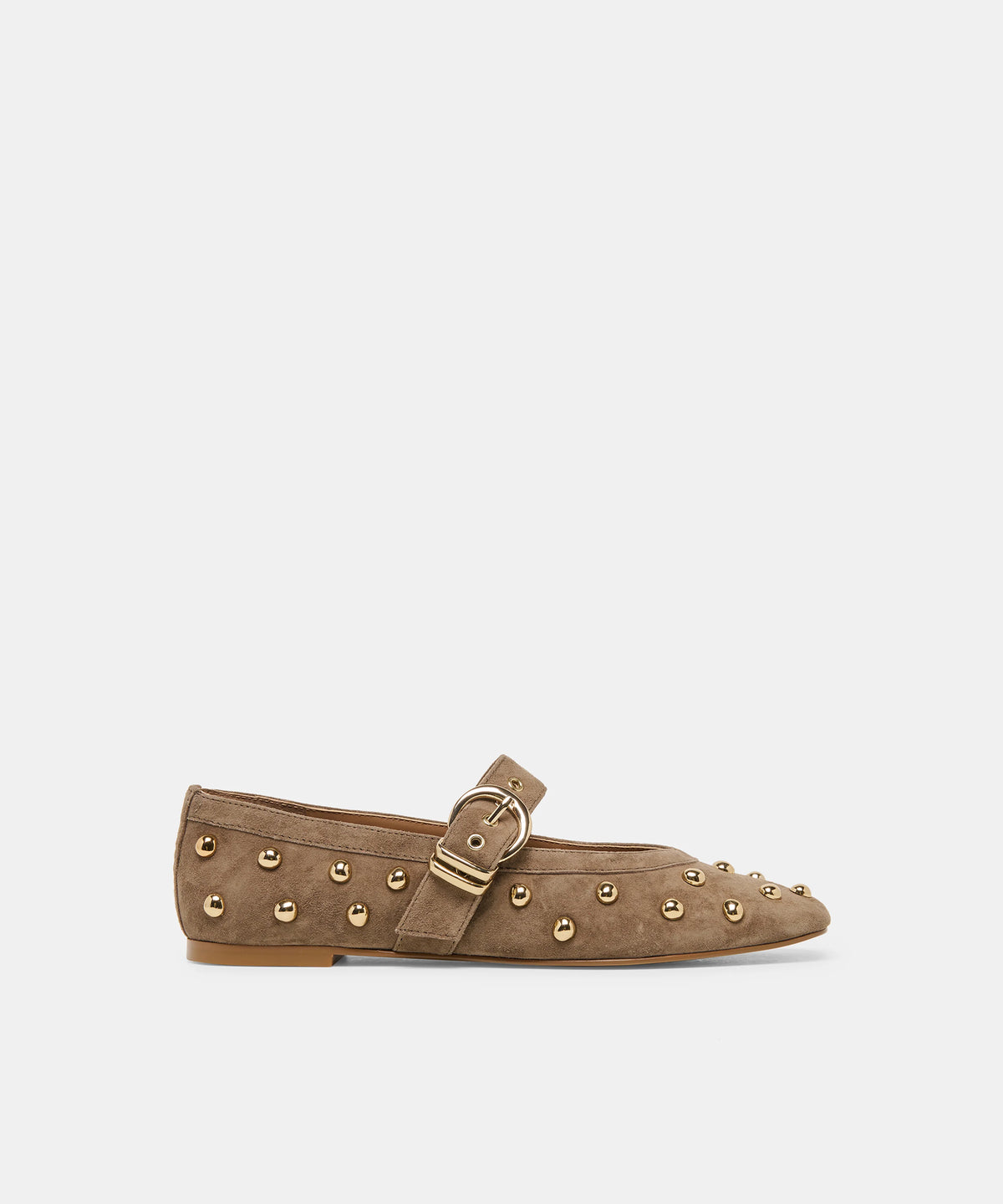 A single taupe-brown suede flat shoe with gold-tone metal studs and a matching buckle strap, shown in profile against a light gray background.