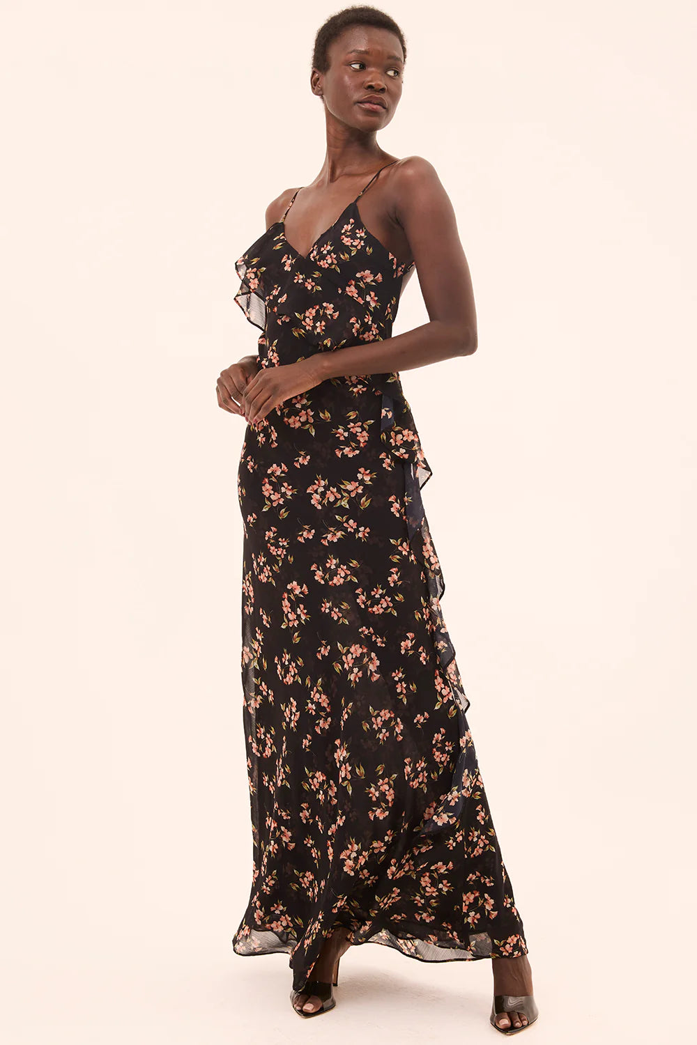 Woman wearing a black floral dress on a white background
