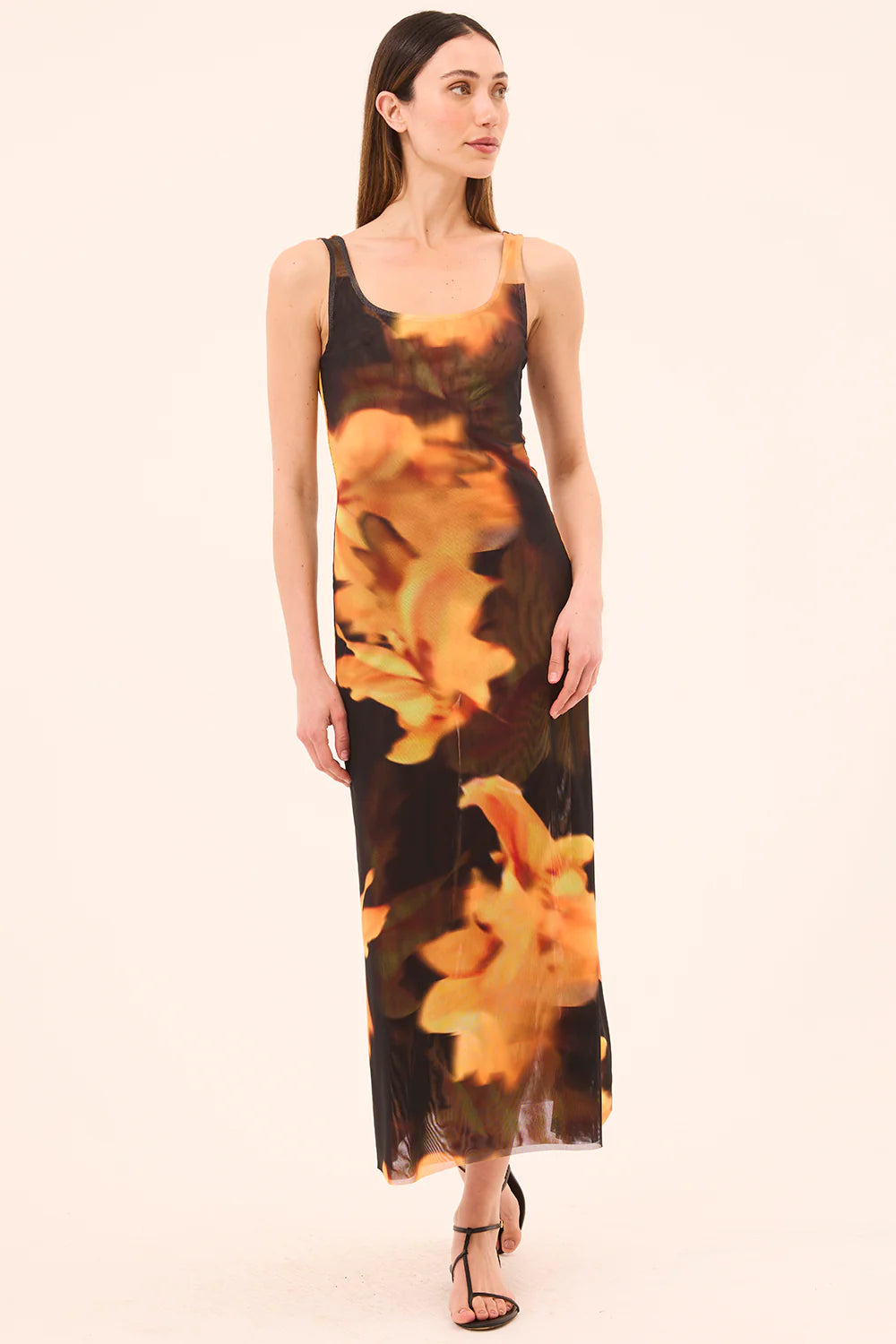 model wearing the khloe yellow flora print dress on a white background