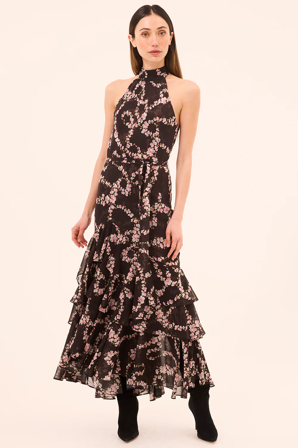 Woman wearing a floral patterned dress on a beige background