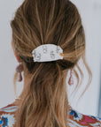 ivory crystal hair tie on a model with a white background