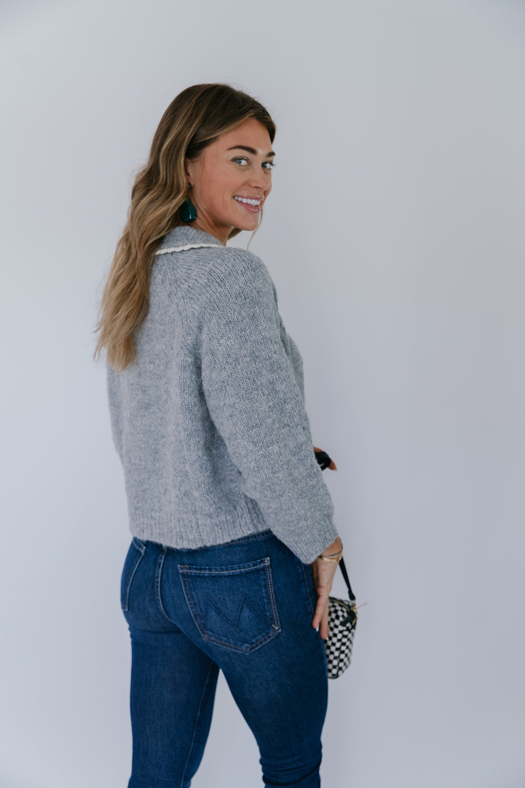 model wearing grey crochet collar cardigan with jeans on a white background, back 