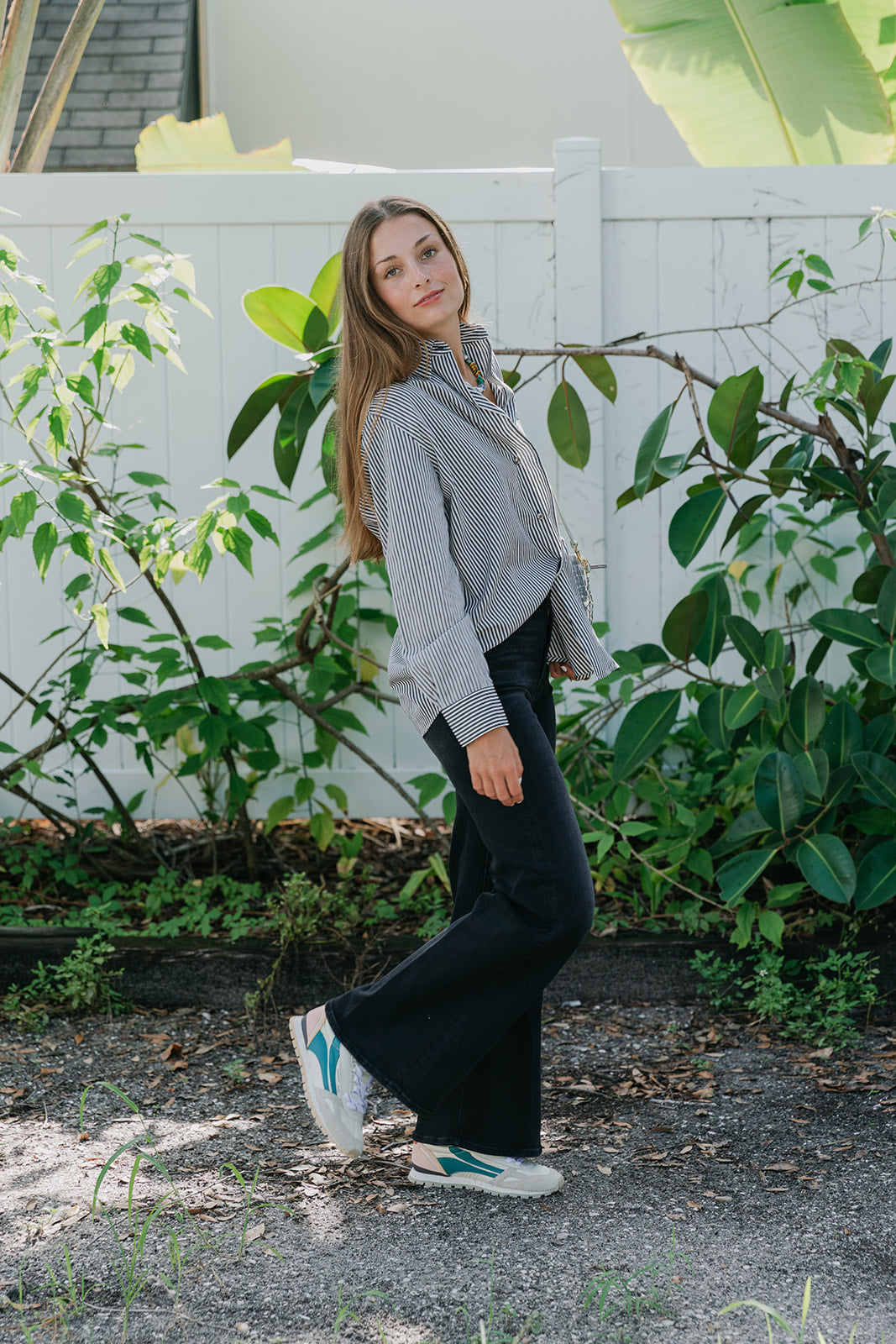Toronto Sneaker shown on a women with black jeans and stripe top