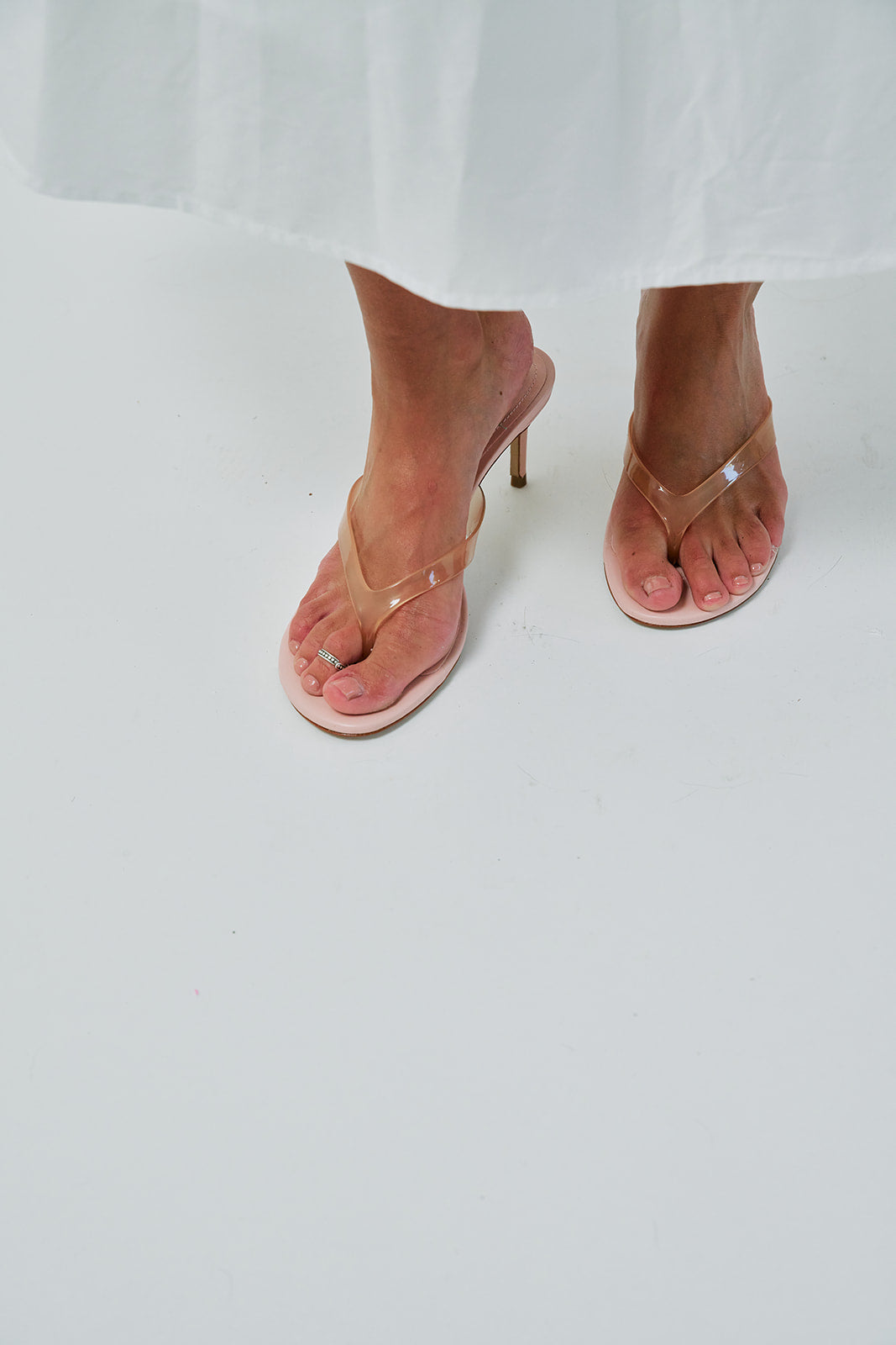 Pink high-heeled sandals on a white background