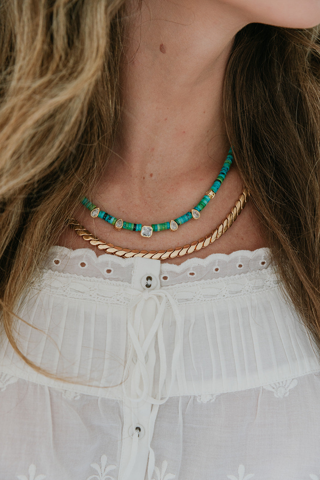 Necklace with green beads and Paloma Chain - L worn by a person with long hair, wearing a white top.