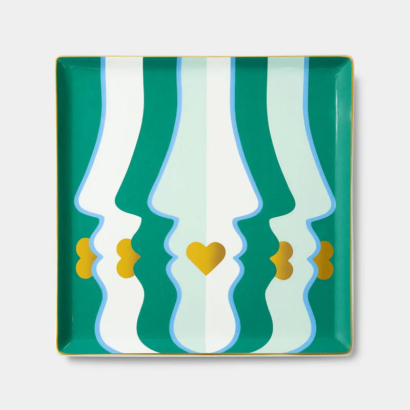 Decorative tray with wavy green and white pattern and gold accents on a light gray background