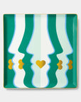 Decorative tray with wavy green and white pattern and gold accents on a light gray background