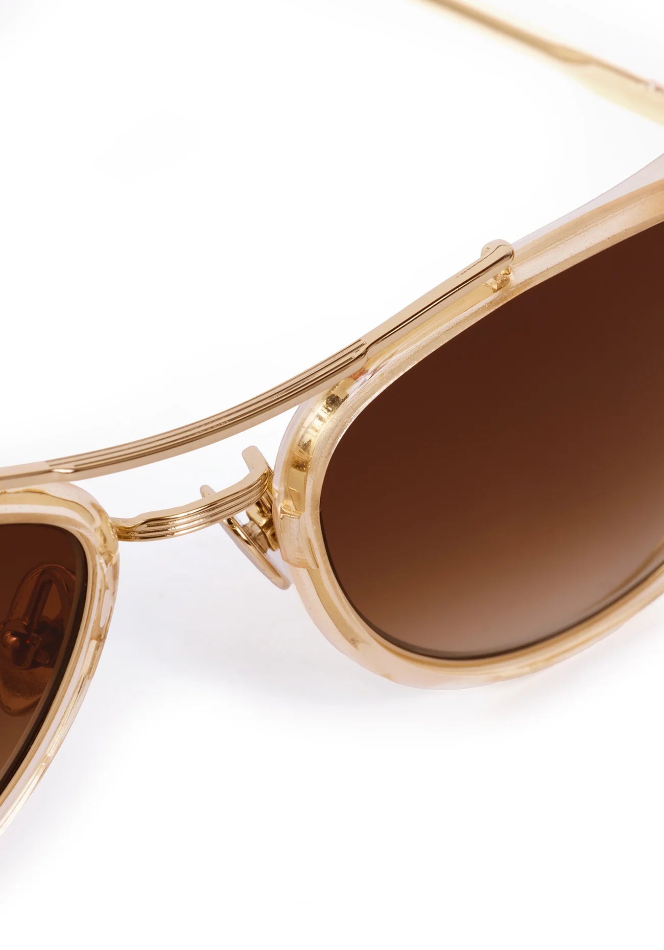 Gold-framed sunglasses with brown lenses on a white background