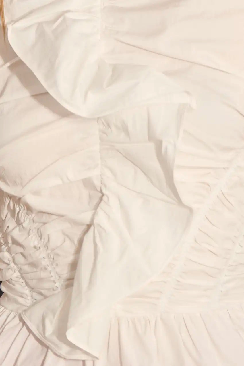 Close-up of a textured white fabric with ruched details