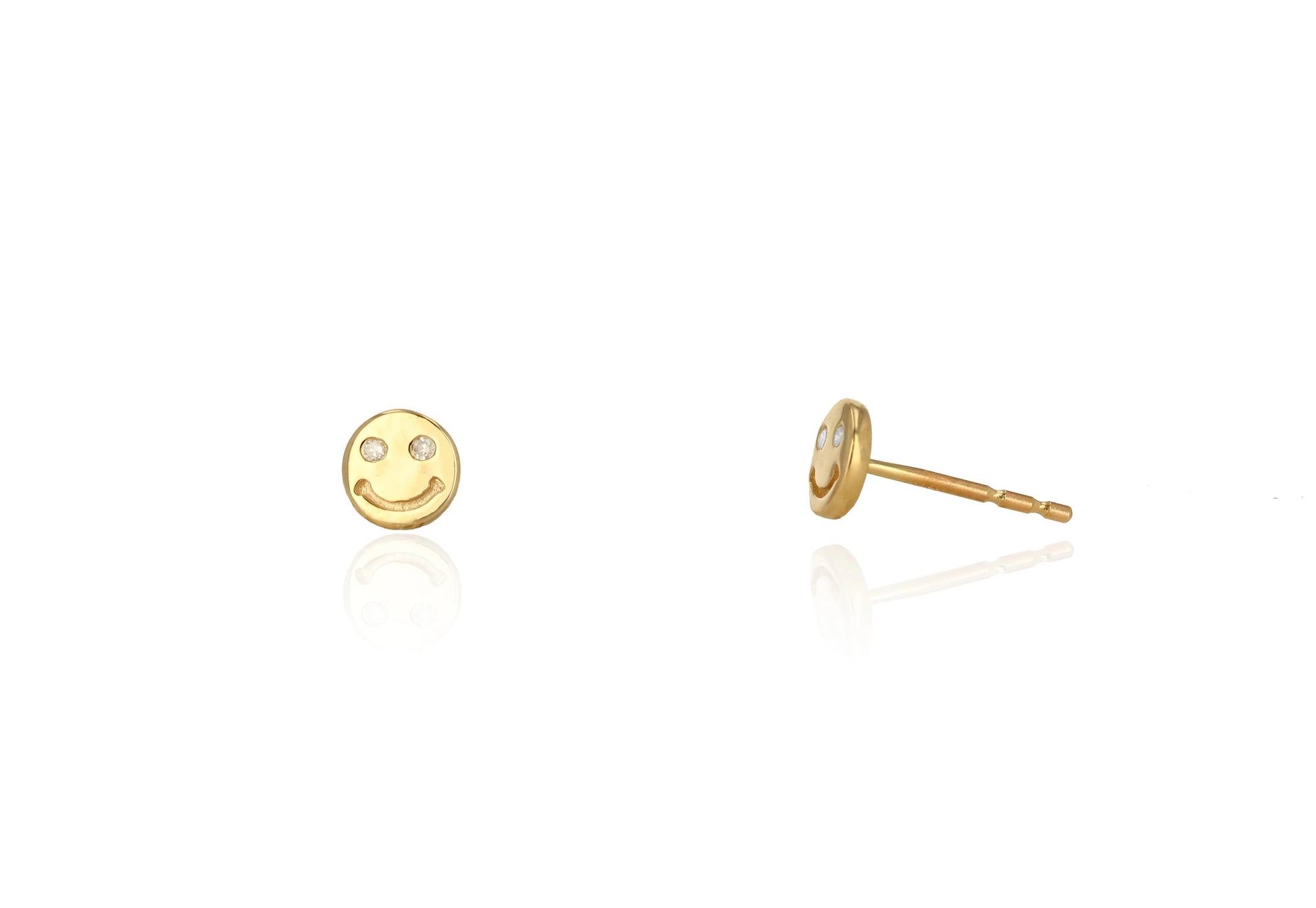 Gold smiley face earrings on a white background