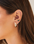 Single Diamond Pear and Round Illusion Stud Earring on ear in second hole