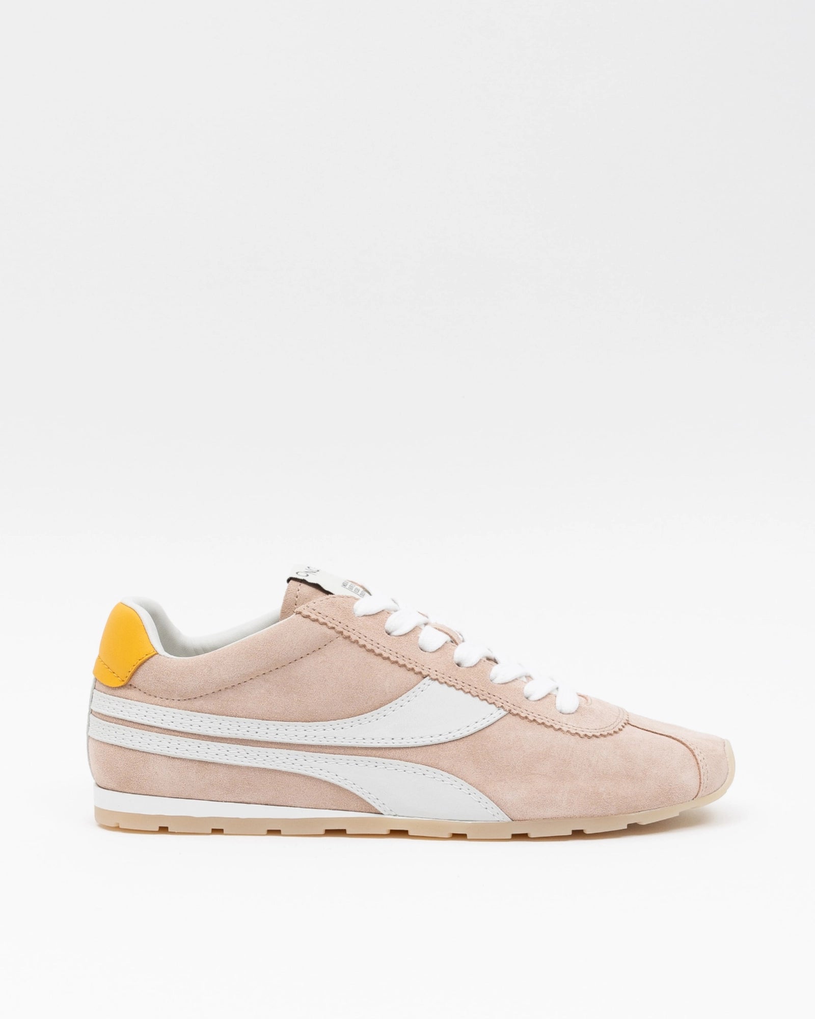 Pink sneaker with white accents on a light beige background