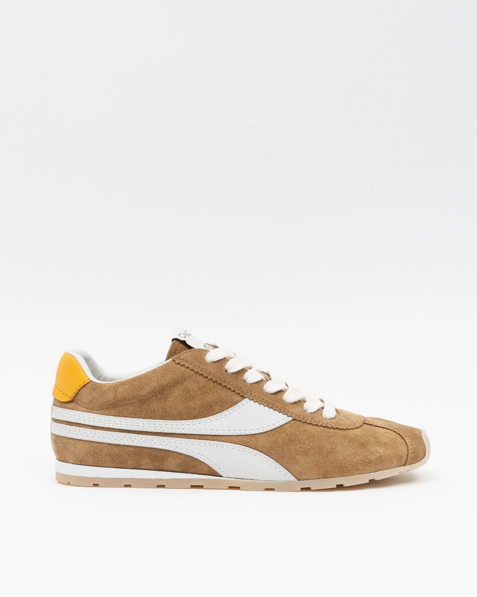 Tan sneaker with white accents on a light gray background