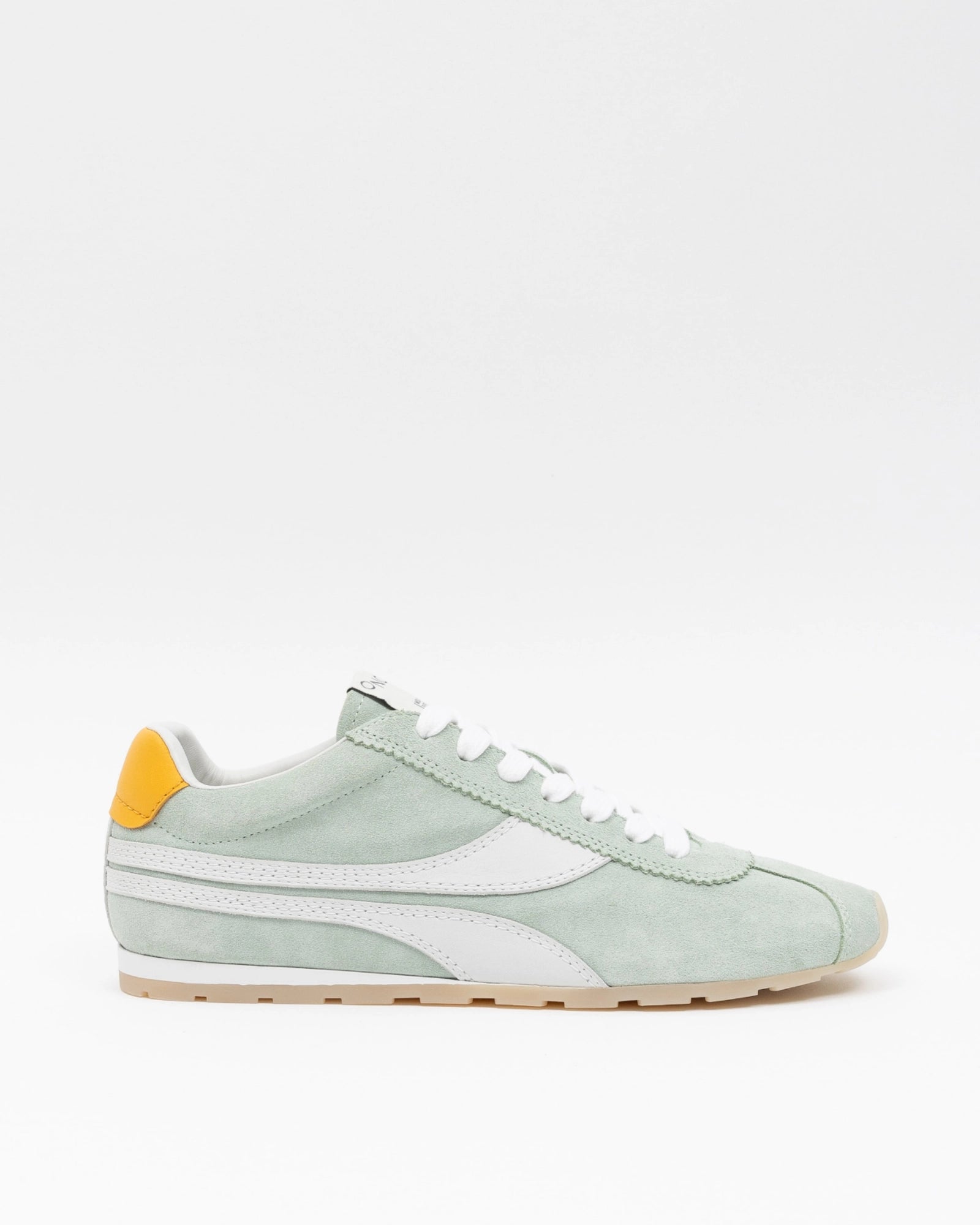 Light green sneaker with a yellow accent on a white background