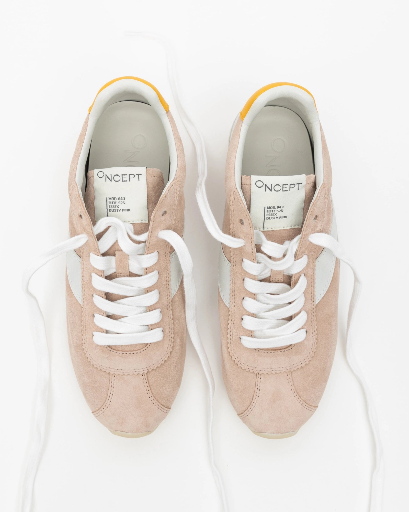 Pair of pink sneakers with white laces on a white background