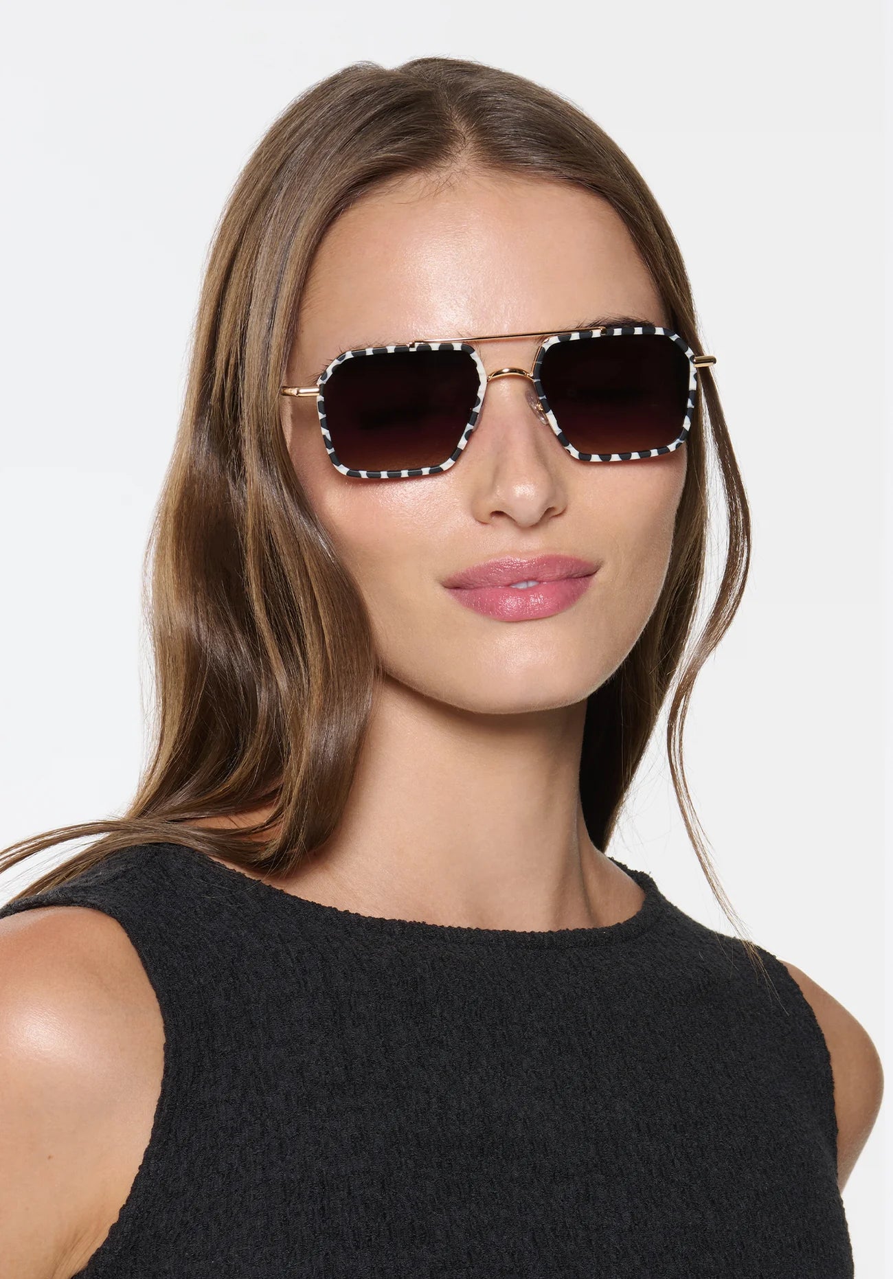 Emery 18K + Matte Domino Sunglasses on model with wide heart faces shape