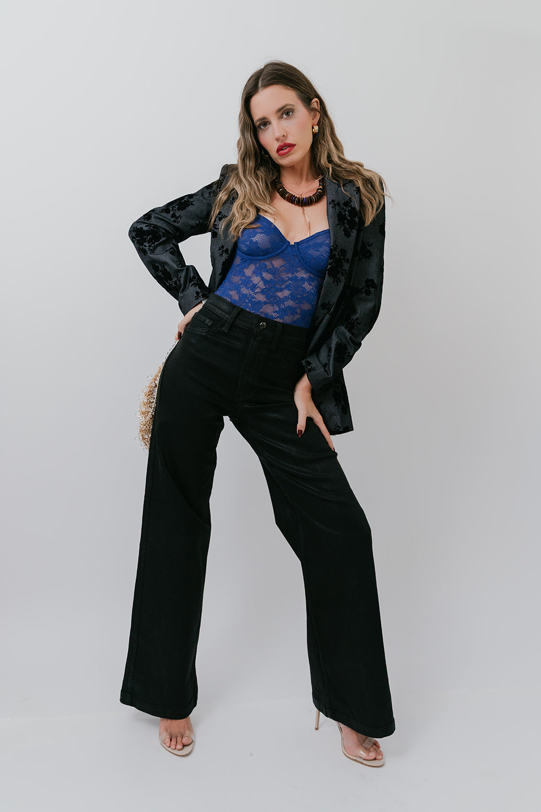Woman wearing Grady Blazer and pants with a blue top against a white background