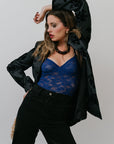 Woman wearing Grady Blazer and blue lace top against a plain background