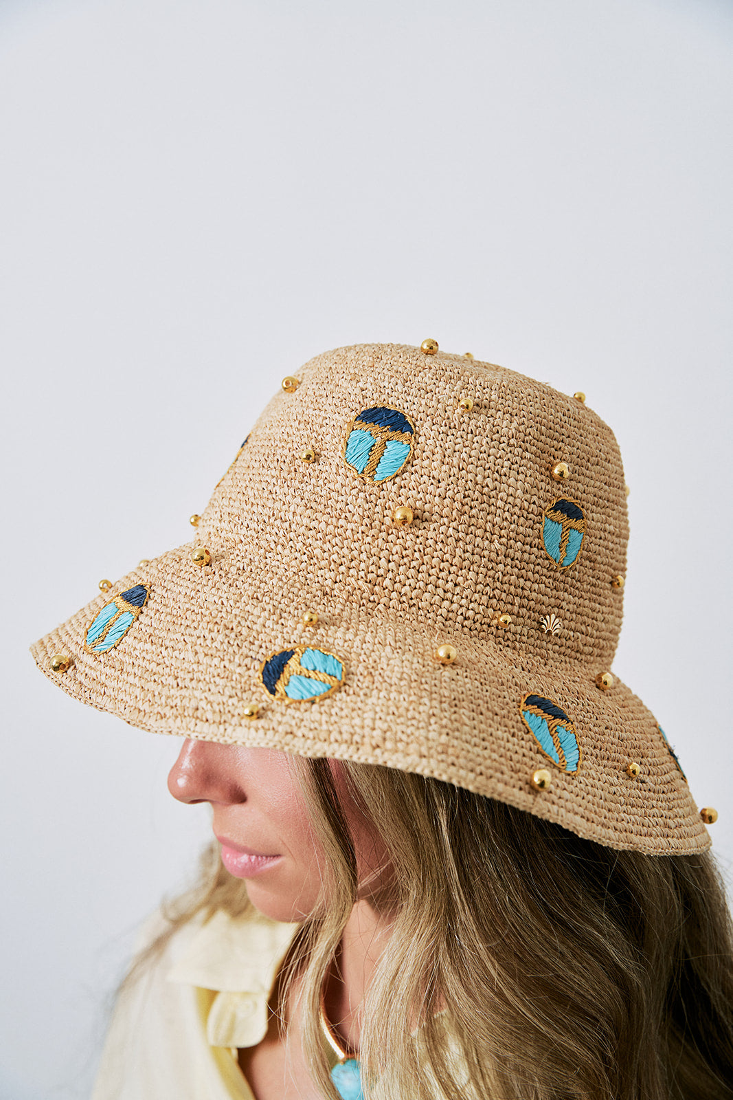 Scarab Embellished Raffia Bucket Hat on model