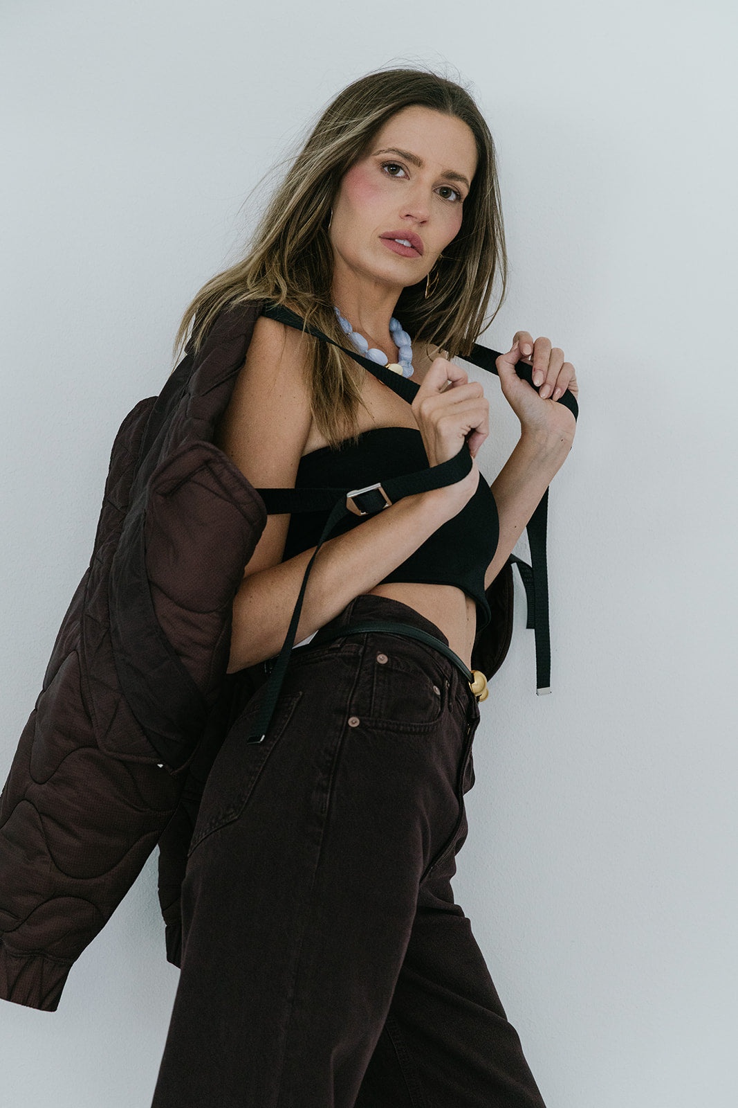Iona Quilted Jacket in Infusion, model holding straps